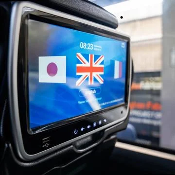 A language selection screen is displayed on a touch monitor mounted behind .. Stock Photos