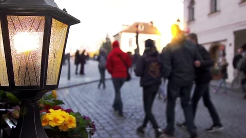 Lantern and flower bed against walking people Stock Footage 74766987
