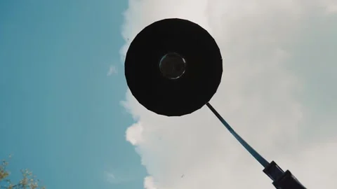 Lantern on a background of blue sky and clouds. Birds are flying behind him Stock Footage 244812417