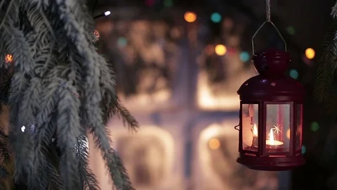 Lantern on a background of snow-covered window with Christmas lights Stock-Footage 70394186