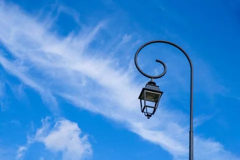 Lantern on a blue sky background. Feathery clouds. Copy space. Stock Photos