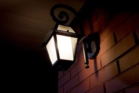 Lantern on a brick wall Stock Photos