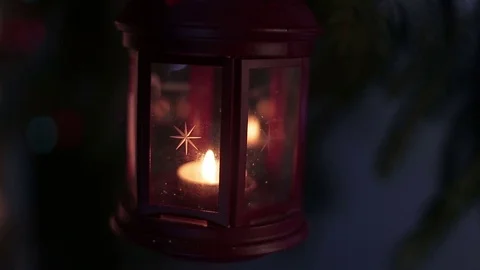 A lantern with a candle on a background of Christmas lights Stock-Footage 70394135