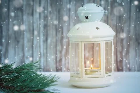 Lantern with candle in snow Stock Photos