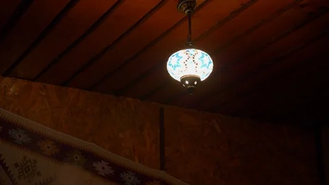 Lantern with colored glass hanging on the ceiling and the smoke from the hookah Stock Footage 124743972