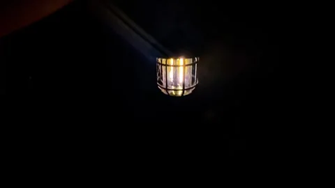 Lantern in the dark, close-up. POV of hand holding lantern. Video stock 302993070
