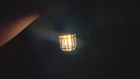 Lantern in the dark, close-up. POV of hand holding lantern. Stock Footage 302993242
