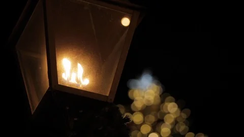 Lantern in Front of Light Up Christmas Tree Stock Footage 112946990