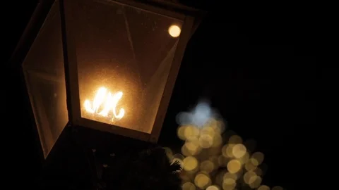 Lantern in Front of Light Up Christmas Tree Stock Footage 112947559
