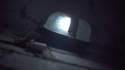 A lantern is hanging on brick wall,lantern light is flashing,due to voltage drop Video stock 107166000