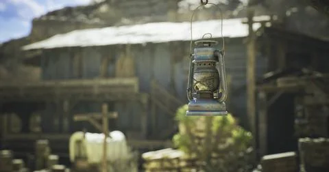 Lantern hanging in front of an old rustic structure with a rustic atmosphere Illustrazione stock