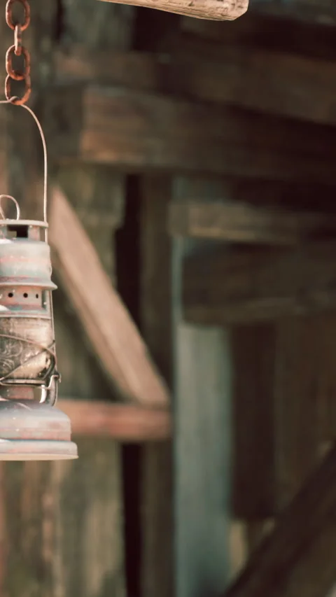 Lantern hanging in a rustic location with wooden background and vintage feel Stock Footage 342127114