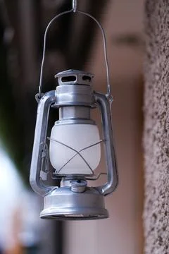 A lantern hanging at a wall Stock Photos