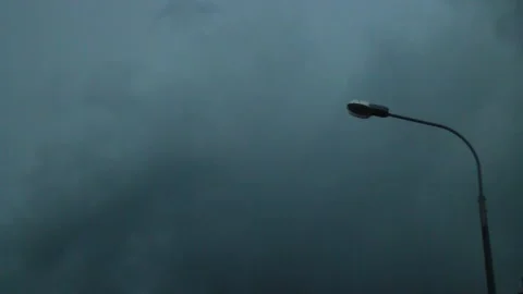 Lantern lamp swaying in the wind against a background of thunderclouds rain hurr Видео 130727591