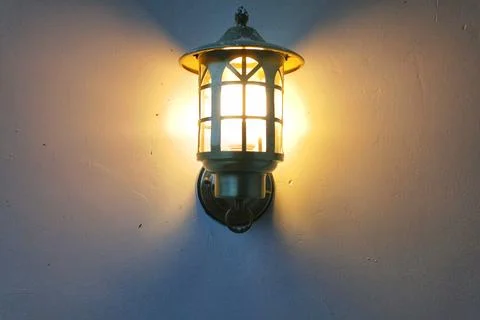 Lantern With A Lamp On White Wall Stock Photos