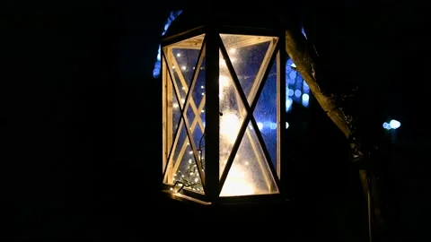 Lantern with LED flashing lights hanging on a tree branch Stock Footage 169187213