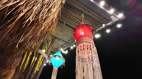 Lantern with a light bulb under a canopy made of bamboo and straw Stock Footage 309128593