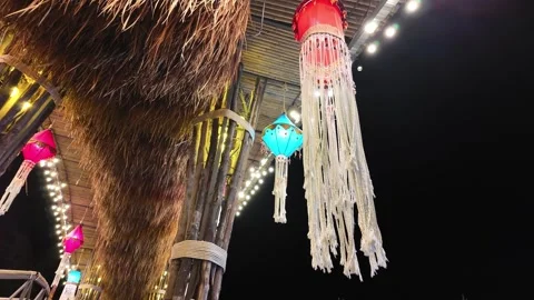 Lantern with a light bulb under a canopy made of bamboo and straw Video stock 309128647