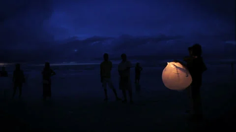 A lantern lights up the late sunset on a beautiful beach Stock Footage 35520914
