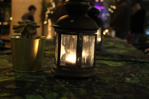 Lantern lit at night on restaurant table Stock Photos