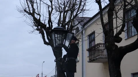 A lantern maker lights kerasin lanterns in the city of Brest in Belarus Stock Footage 297390212