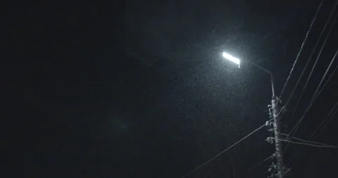The lantern is on at night and it's snowing Stock Footage 143419173
