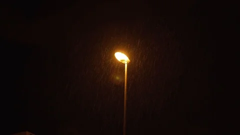The lantern on the pole shines at night when it rains Video stock 125874475
