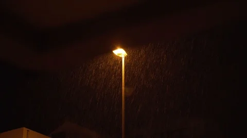 The lantern on the pole shines at night when it rains Stock Footage 125874497