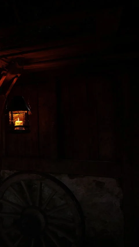 Lantern shines inside a rustic barn during nighttime Stock Footage 339777071
