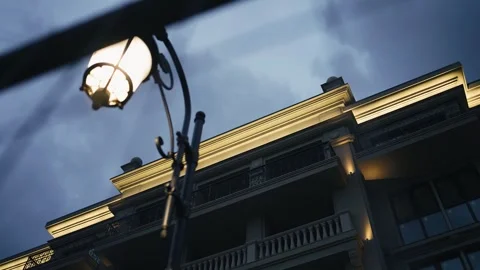 The lantern shines in the night illuminating the building and the street Stock Footage 256054015