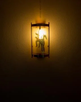 Lantern shining in the dark fixed on the wall Stock Photos