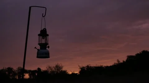Lantern silhouetted in sunrise Video stock 11140690