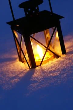 Lantern in snow Stock Photos