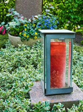 A lantern stands in front of a tombstone 写真素材