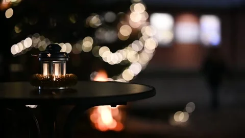 Lantern stands on the table next to a decorated Christmas tree. Stock Footage 258229566