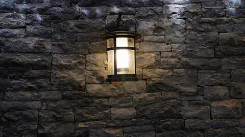 Lantern on a stone wall. old lantern .gray stone wall with lantern Stock-Fotos