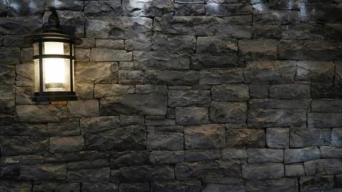 Lantern on a stone wall. old lantern .gray stone wall with lantern Stock Photos