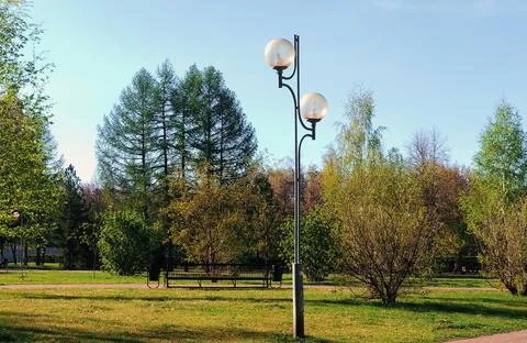 Lantern in the summer park on the background of trees and green grass Stock-Fotos