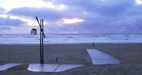 Lantern sways in the wind on the shores of the North Sea in the evening. Stock Footage 247648667