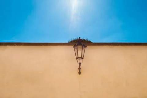 The lantern on the wall against the sky Stock Photos