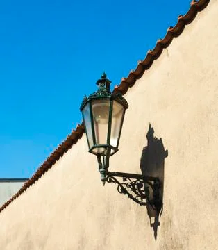 The lantern on the wall against the sky Stock Photos