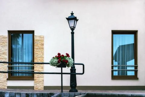 Lantern, wall and two windows. Stock Photos