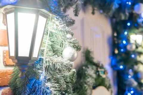 Lantern on the wall with pine branches Stock Photos