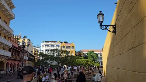 Lantern on Yellow Wall Above Crowded Plaza Street, Cartagena, Colombia 8K Stock Footage 331499403