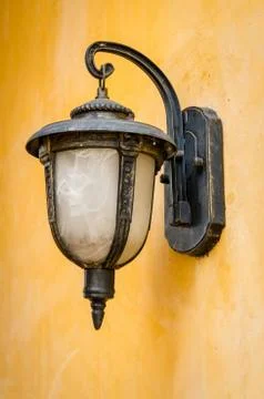 Lantern on a yellow wall Stock Photos