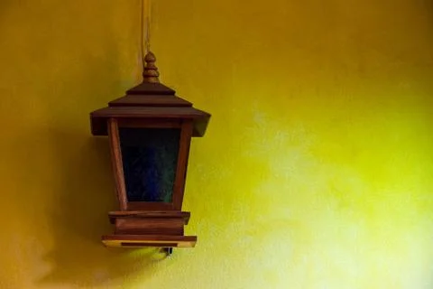 Lantern on a yellow wall Stock Photos