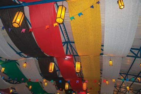 Lanterns on ceiling and colored fabric bands Stock Photos