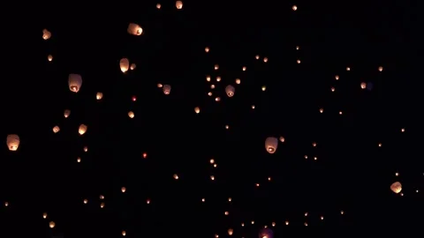 Lanterns flying through the night sky over Bayonne, France. Stock Footage 259409150
