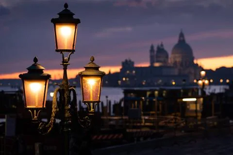 Lanterns in front of sunset behind Santa Maria della Salute in Venice Stock Photos