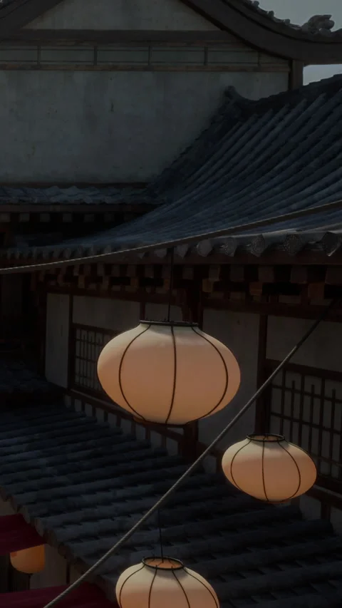 Lanterns hang over traditional building in evening light near narrow street 스톡 동영상 341986284